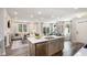 Open kitchen with island, stainless steel appliances, and views to living room at 1878 Sweet Gardenia Way, Apex, NC 27502