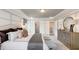 Spacious main bedroom with trey ceiling, large dresser, and sitting area at 1878 Sweet Gardenia Way, Apex, NC 27502