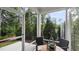 Relaxing screened porch with wooden table and chairs at 1878 Sweet Gardenia Way, Apex, NC 27502