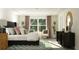 Spacious main bedroom with a large window and seating area at 1888 Sweet Gardenia Way, Apex, NC 27502