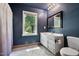 Bathroom with white vanity, shower, and a window overlooking the backyard at 200 Cedarwood Dr, Erwin, NC 28339