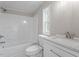 Updated bathroom with white vanity, tub, and shower at 262 Homestead Dr, Selma, NC 27576
