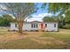 Newly renovated mobile home with gray siding and red door, situated on a spacious lot at 262 Homestead Dr, Selma, NC 27576