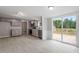 Open concept kitchen with gray cabinets and access to a deck at 262 Homestead Dr, Selma, NC 27576