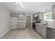 Gray cabinets, granite countertops, and stainless steel appliances in this updated kitchen at 262 Homestead Dr, Selma, NC 27576