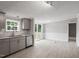 Modern kitchen featuring gray cabinets, granite countertops, and stainless steel appliances at 262 Homestead Dr, Selma, NC 27576