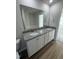 Double vanity bathroom with granite countertops and large mirror at 359 Magnolia Run Way, Benson, NC 27504