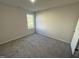 Well-lit bedroom with carpeted flooring and a large window at 359 Magnolia Run Way, Benson, NC 27504