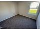 Simple bedroom with carpeted floors and a window offering natural light at 359 Magnolia Run Way, Benson, NC 27504