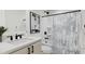 Clean bathroom with shower/tub combo, white vanity, and modern fixtures at 4075 Elk Creek Ln # 9, Raleigh, NC 27612
