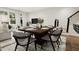 Modern dining area with a wood table and gray chairs near stairs at 4075 Elk Creek Ln # 9, Raleigh, NC 27612