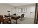 Spacious home office with a large desk, two chairs, and built-in shelving at 4075 Elk Creek Ln # 9, Raleigh, NC 27612