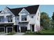 Modern two-story home with white siding and black accents at 4077 Elk Creek Ln, Raleigh, NC 27612