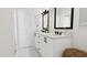 Stylish bathroom featuring double vanity with black fixtures and modern white cabinetry at 4077 Elk Creek Ln, Raleigh, NC 27612