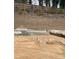 Construction site showing foundation work and landscape retaining wall under construction at 4077 Elk Creek Ln, Raleigh, NC 27612