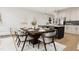 Inviting dining room with wooden table, modern chairs, and views of open kitchen area at 4077 Elk Creek Ln, Raleigh, NC 27612