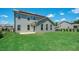 Two-story house with gray siding, solar panels, and a sunroom addition at 519 River Dell Townes Ave, Clayton, NC 27527