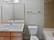 Clean bathroom with single sink vanity, toilet and bathtub at 5211 Blue Lagoon Ln, Raleigh, NC 27610