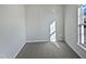 Bright bedroom with grey carpet and large window at 5211 Blue Lagoon Ln, Raleigh, NC 27610