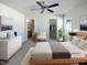 Virtually staged bedroom with large bed, dresser, and ensuite bathroom at 5211 Blue Lagoon Ln, Raleigh, NC 27610