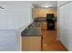 Kitchen with light wood cabinets, dark countertops, and black appliances at 5211 Blue Lagoon Ln, Raleigh, NC 27610