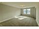 Spacious bedroom with carpet and large windows at 554 Eversden Dr, Zebulon, NC 27597