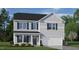 Two-story house with gray siding, dark green shutters, and a white door at 70 Saddle Mare St, Clayton, NC 27520