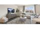 Living room with sectional sofa, coffee table, and large window at 70 Saddle Mare St, Clayton, NC 27520