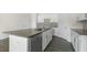 Kitchen island with granite countertop, stainless steel dishwasher, and gray floors at 862 Old Tarboro Rd, Wendell, NC 27591