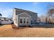 Two-story house with sunroom and attached patio, showcasing a modern design at 88 Capewood Ct, Garner, NC 27529
