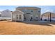 Two-story house with sunroom and attached patio, showcasing a modern design at 88 Capewood Ct, Garner, NC 27529