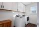 Laundry room with washer, dryer, and cabinets at 88 Capewood Ct, Garner, NC 27529