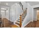 Elegant staircase with wrought iron railing and hardwood steps at 88 Capewood Ct, Garner, NC 27529