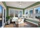 Relaxing sunroom with light-filled windows and comfortable seating at 88 Capewood Ct, Garner, NC 27529