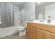 Clean bathroom with tub shower, wood vanity, and gray geometric shower curtain at 103 Marion Dr, Erwin, NC 28339