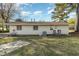 Rear view of the home, showcasing a patio and yard at 103 Marion Dr, Erwin, NC 28339