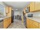 Kitchen with wood cabinets, stainless steel appliances, and tile floor at 103 Marion Dr, Erwin, NC 28339