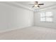Spacious bedroom with ceiling fan and neutral carpeting at 1039 Brockton Dr, Mebane, NC 27302
