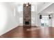 Two-story great room with a stone fireplace and hardwood floors at 1039 Brockton Dr, Mebane, NC 27302