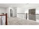 Upper hallway features carpet, bathroom access, and stone fireplace at 1039 Brockton Dr, Mebane, NC 27302