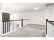 Upper hallway with carpet, stone fireplace feature, and white railings at 1039 Brockton Dr, Mebane, NC 27302