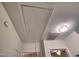 Attic access panel on a white ceiling with a pull cord and nearby ceiling light at 121 Lumina Pl, Holly Springs, NC 27540