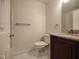 Bright bathroom features a granite-topped vanity and a combination shower and tub at 121 Lumina Pl, Holly Springs, NC 27540