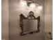 Close-up of a powder room mirror and vanity lighting at 121 Lumina Pl, Holly Springs, NC 27540