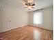 Bright bedroom featuring a ceiling fan, natural light, and gleaming hardwood floors at 121 Lumina Pl, Holly Springs, NC 27540