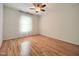 Bedroom features hardwood floors, one window, and white walls at 121 Lumina Pl, Holly Springs, NC 27540