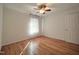 Bright bedroom featuring a ceiling fan, natural light, and gleaming hardwood floors at 121 Lumina Pl, Holly Springs, NC 27540