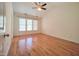Bedroom with vaulted ceiling, three windows, and hardwood flooring at 121 Lumina Pl, Holly Springs, NC 27540