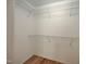 Walk in closet with white walls, wire shelving, and hardwood floors at 121 Lumina Pl, Holly Springs, NC 27540