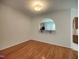 Dining area with hardwood floors and a view into the kitchen through an arched opening at 121 Lumina Pl, Holly Springs, NC 27540